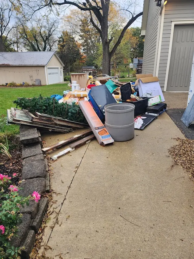 Dumpster being loaded with debris for Roofing Dumpster Rental in Ramsey